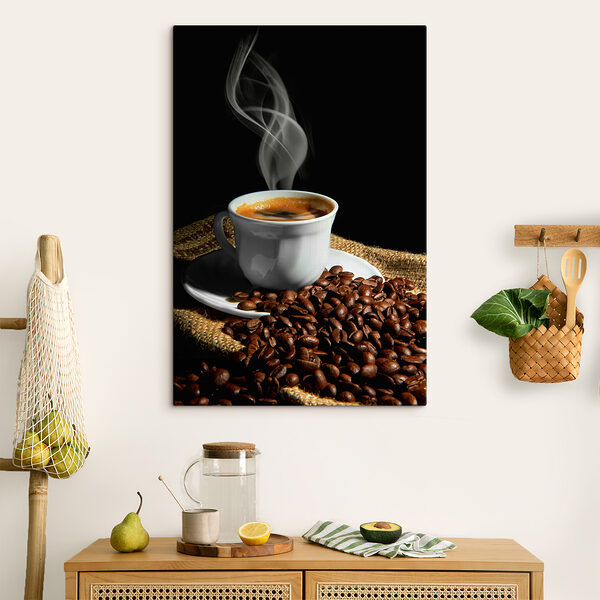 A cup of coffee with smoke on a saucer and beans A cup of coffee with smoke on a saucer and beans